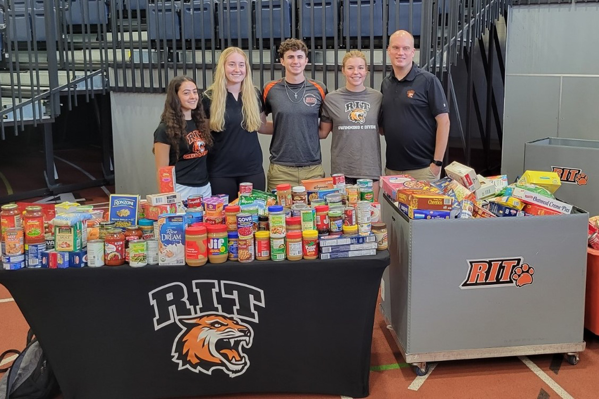 four people in front of canned food table
