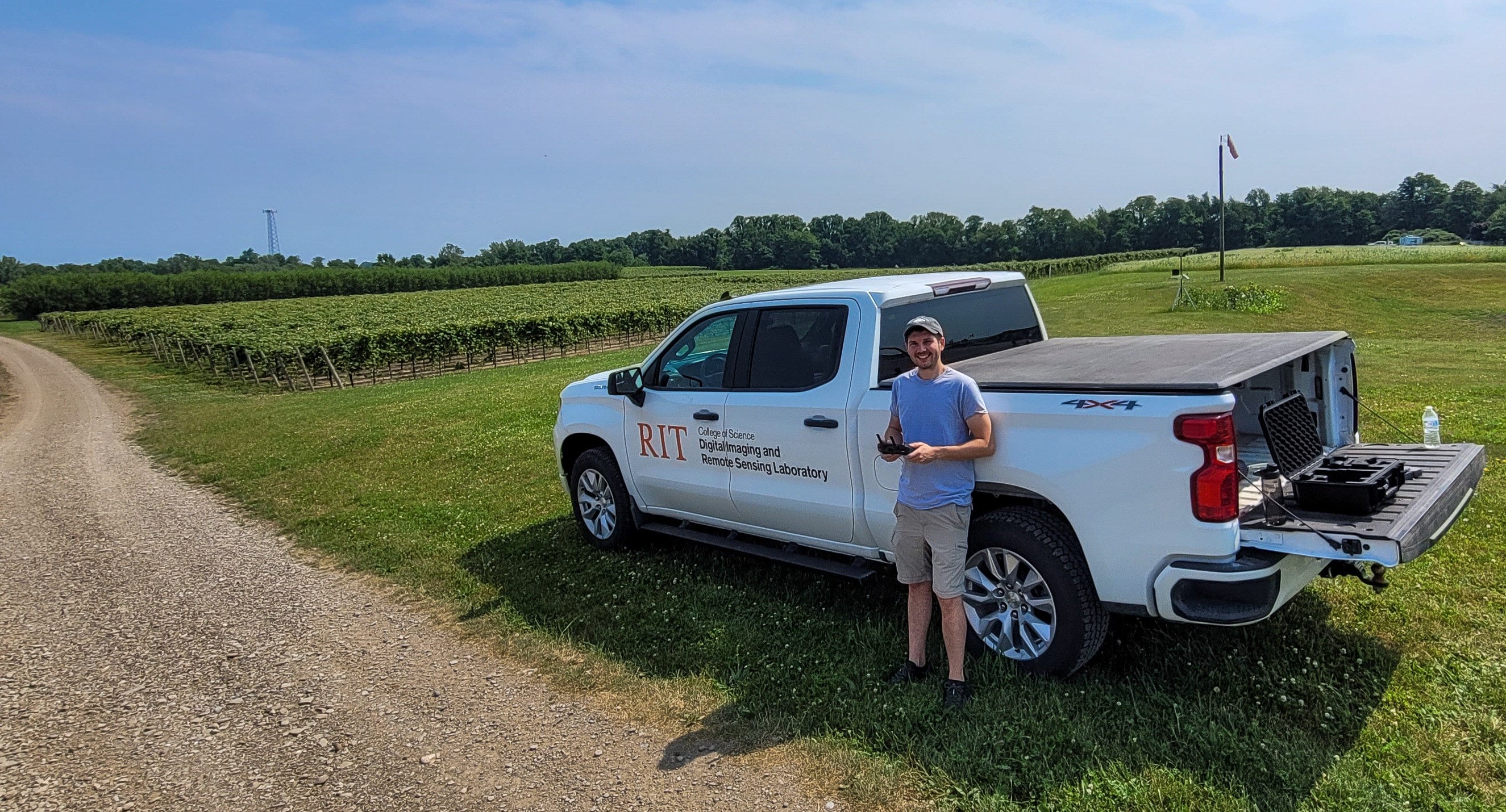 Rob in front of the DIRS truck while monitoring a DJI Mavic 3 Multispectral drone flight over the CLEREL study vineyards in the background. (June 2024)
