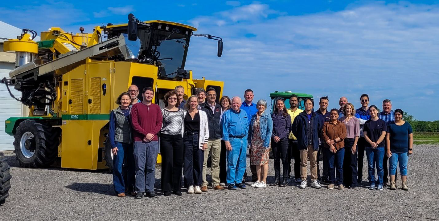 Jan and Rob among the greater HiRes Vineyard Nutrition science teams and advisory committee, posing in front of CLEREL's grape harvester. (May 2025)