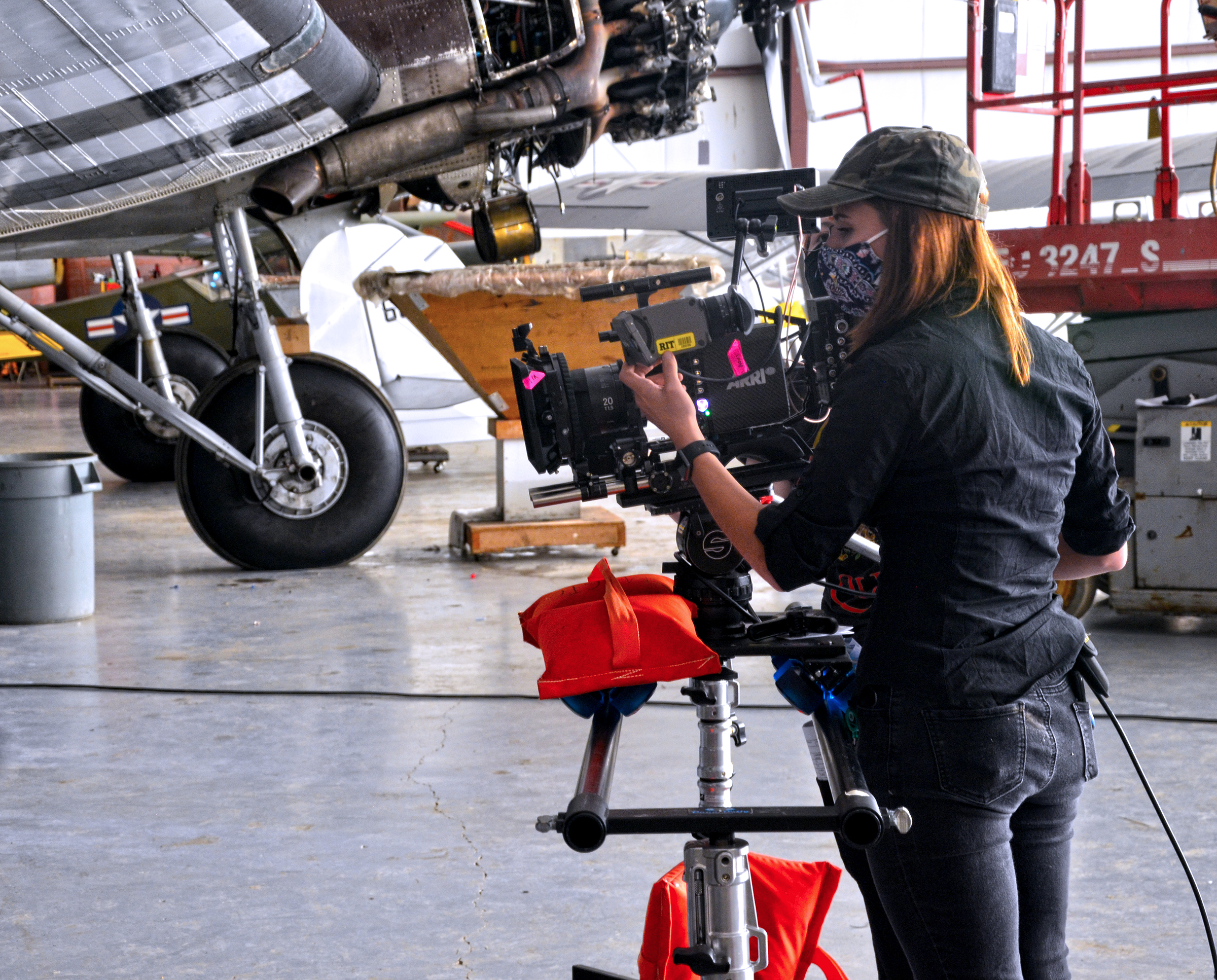 person with camera in airplane museum