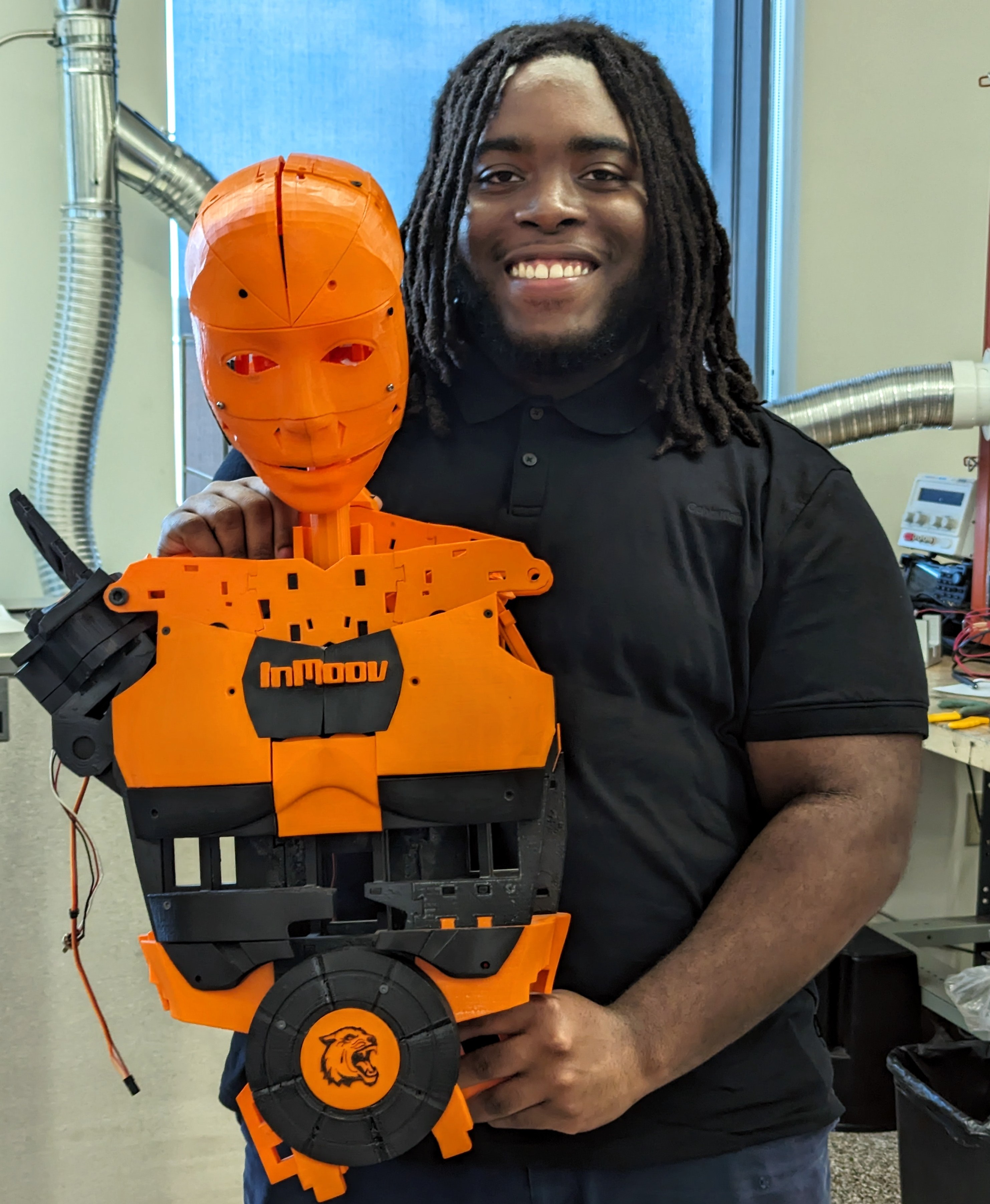 black man holding orange and black figure