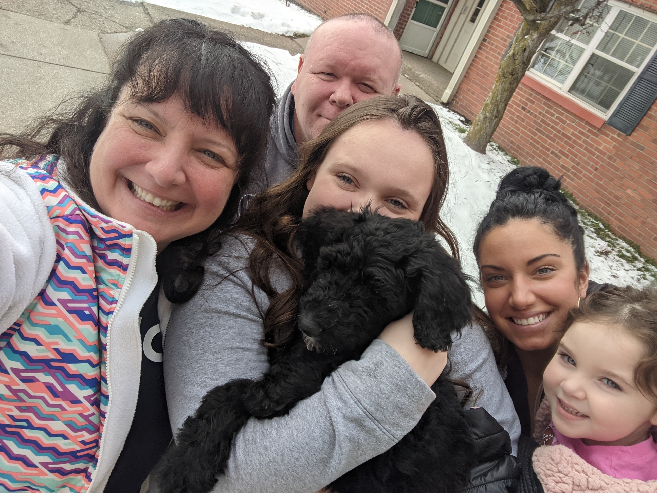 group of people with a puppy