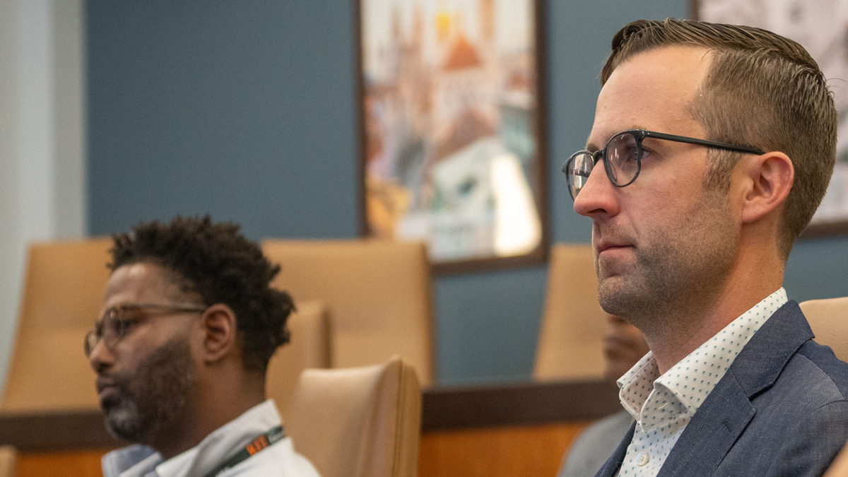 Two men sitting in a lecture room