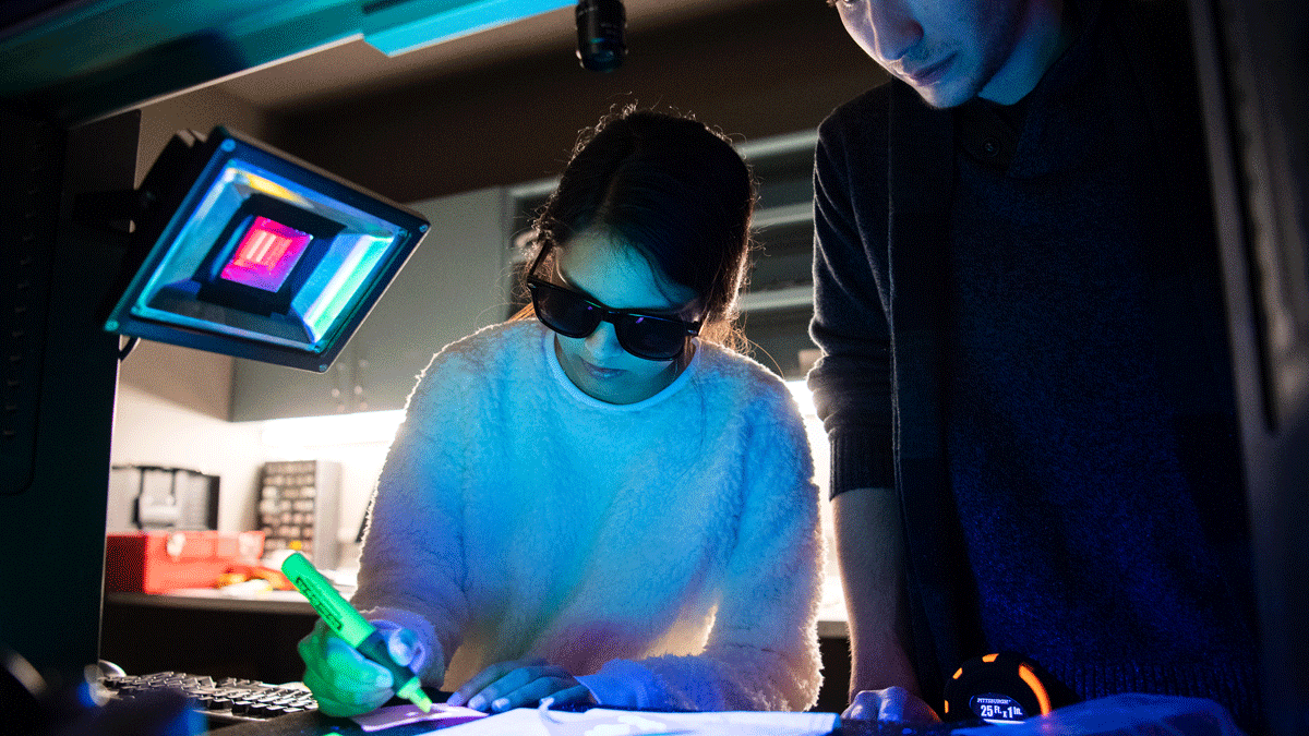 Two students working on a project in lab and girl is holding a highlighter