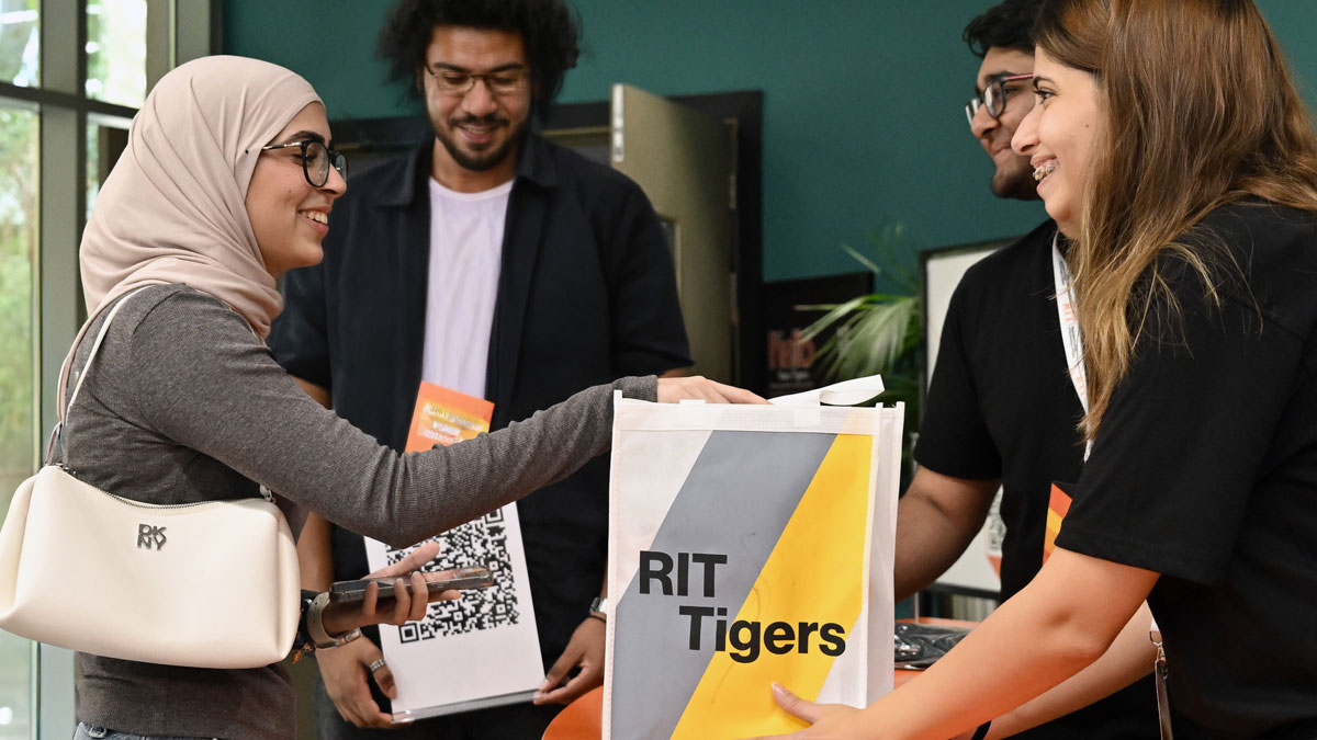 RIT student receiving a welcome pack