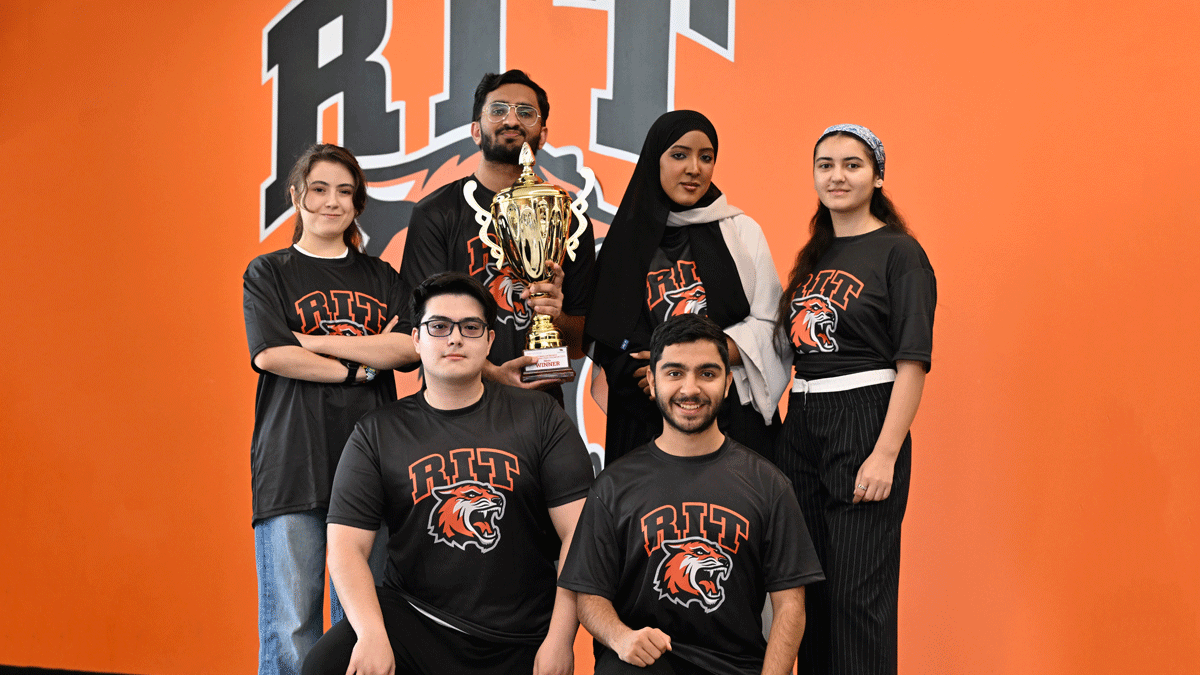 A group of athletes posing for a picture with winning trophie