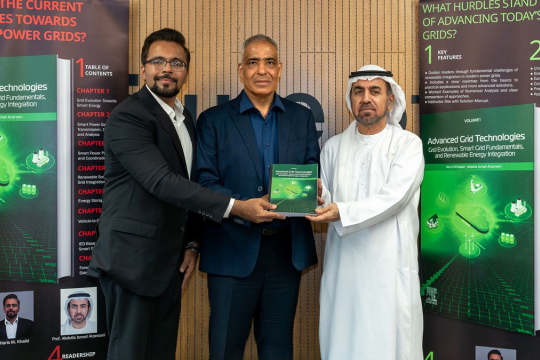 Dr. Abdulla Ismail presenting his textbook to RIT Dubai president