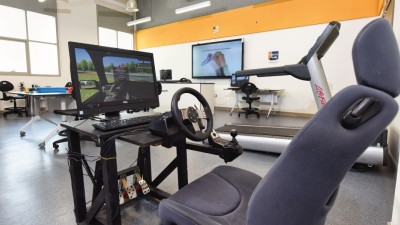 Sim racing rig with steering wheel, pedals, and shifter
