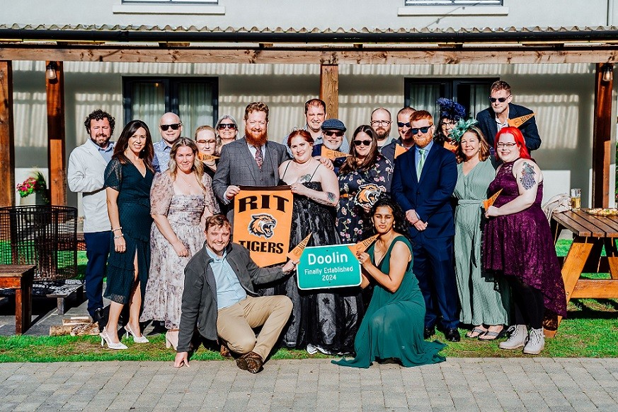 Lisa Kachigian BS ’03 and Joshua Doolin BS ’11 surrounded by friends and family