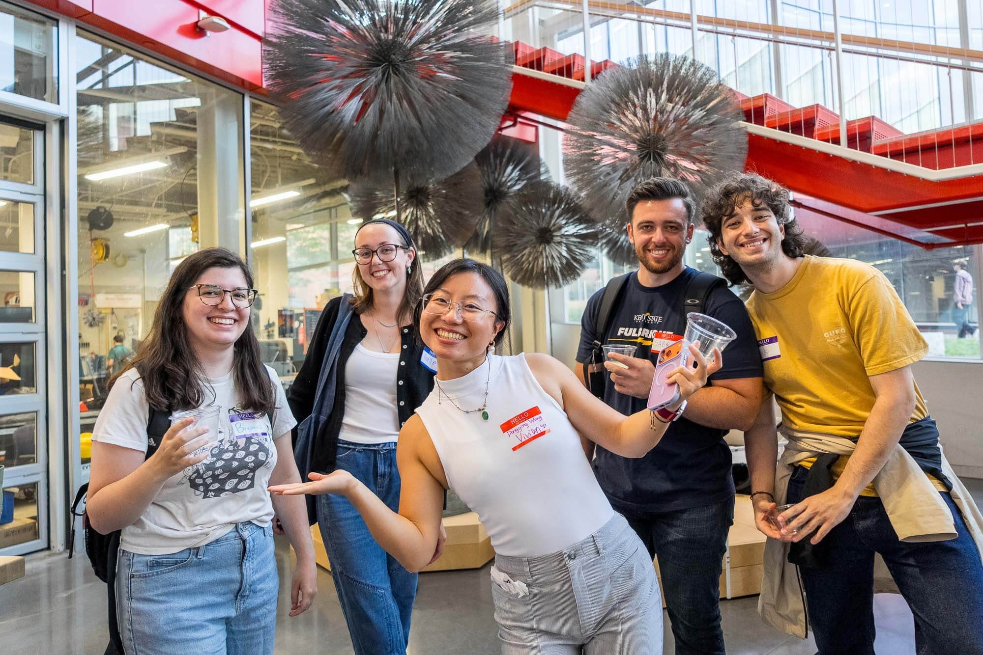 Five RIT graduate students pose together at the 2026 Graduate Orientation Semester Kickoff in the SHED.