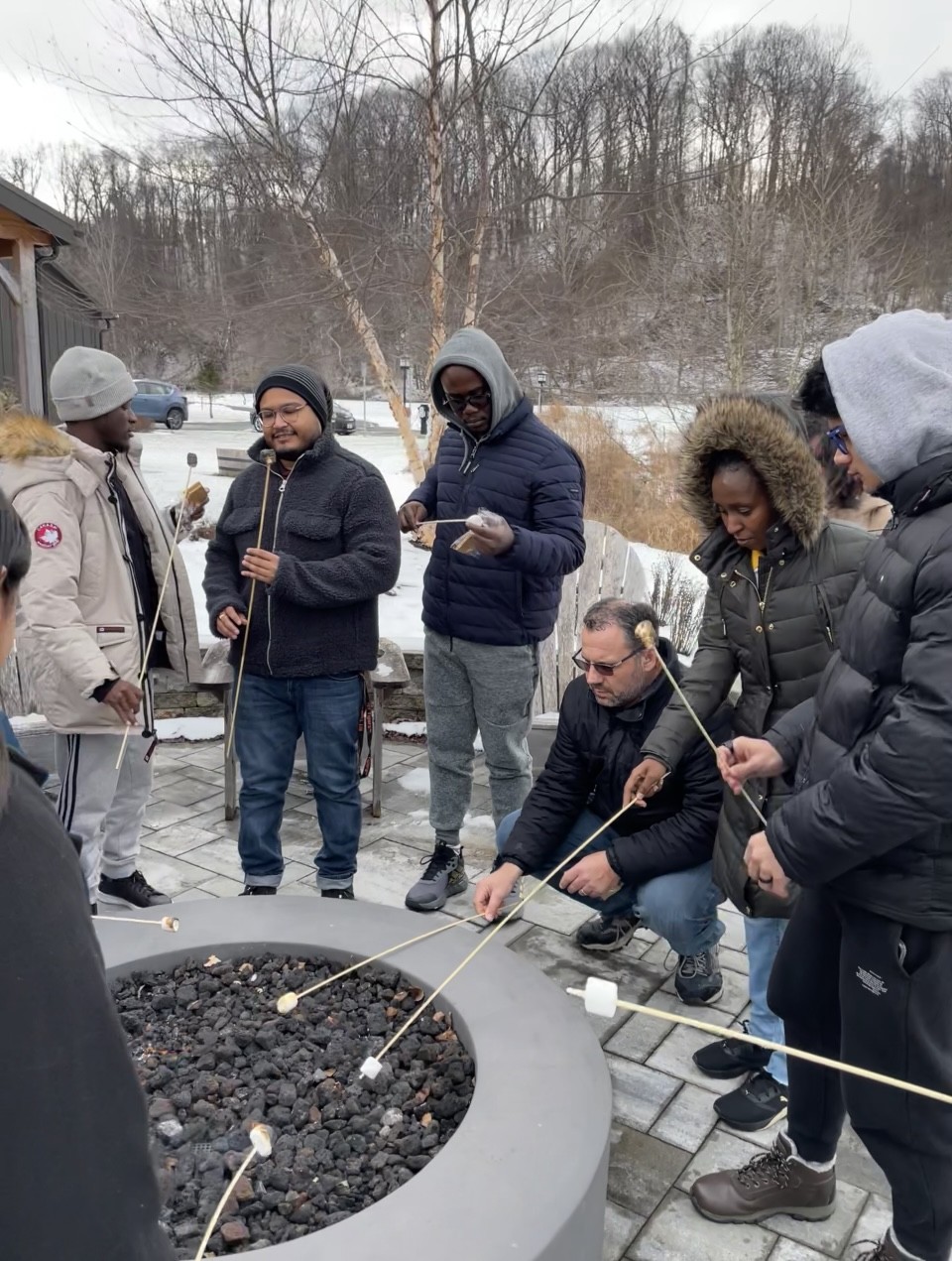photo of students around a campfire roasting marshmallows