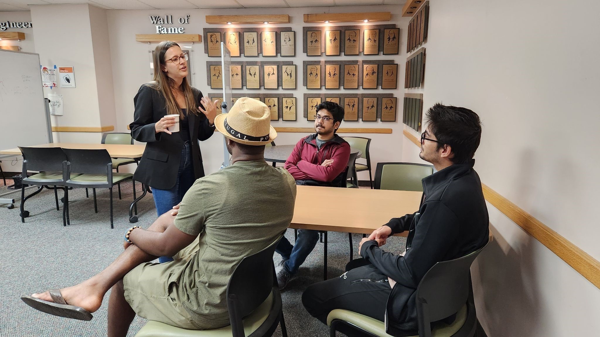 Dr. Renata Rezende Miranda talked with AWARE-AI trainees Justin Namba, Saurav Singh, and other participants.
