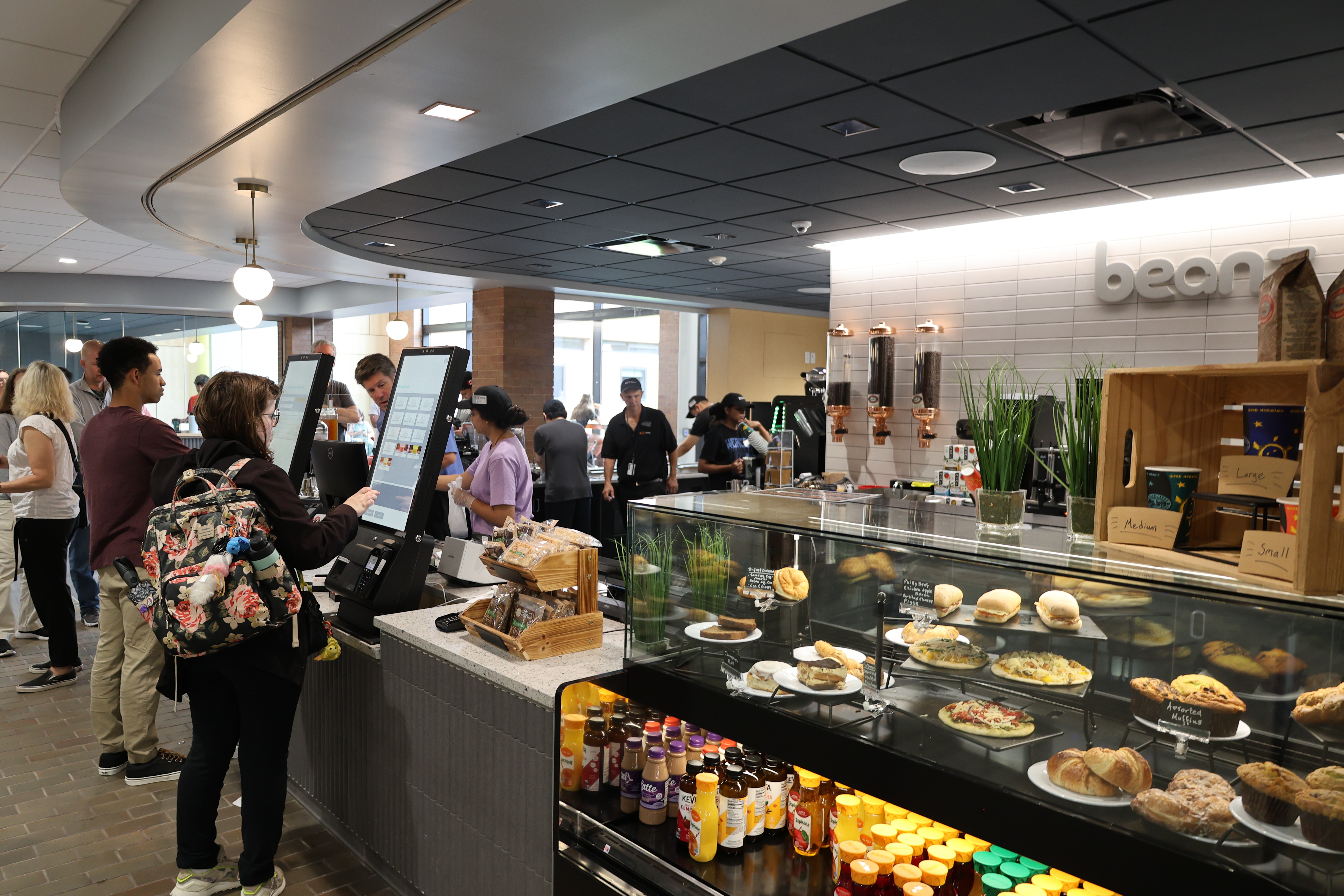 Students using the digital kiosk to order from Beanz