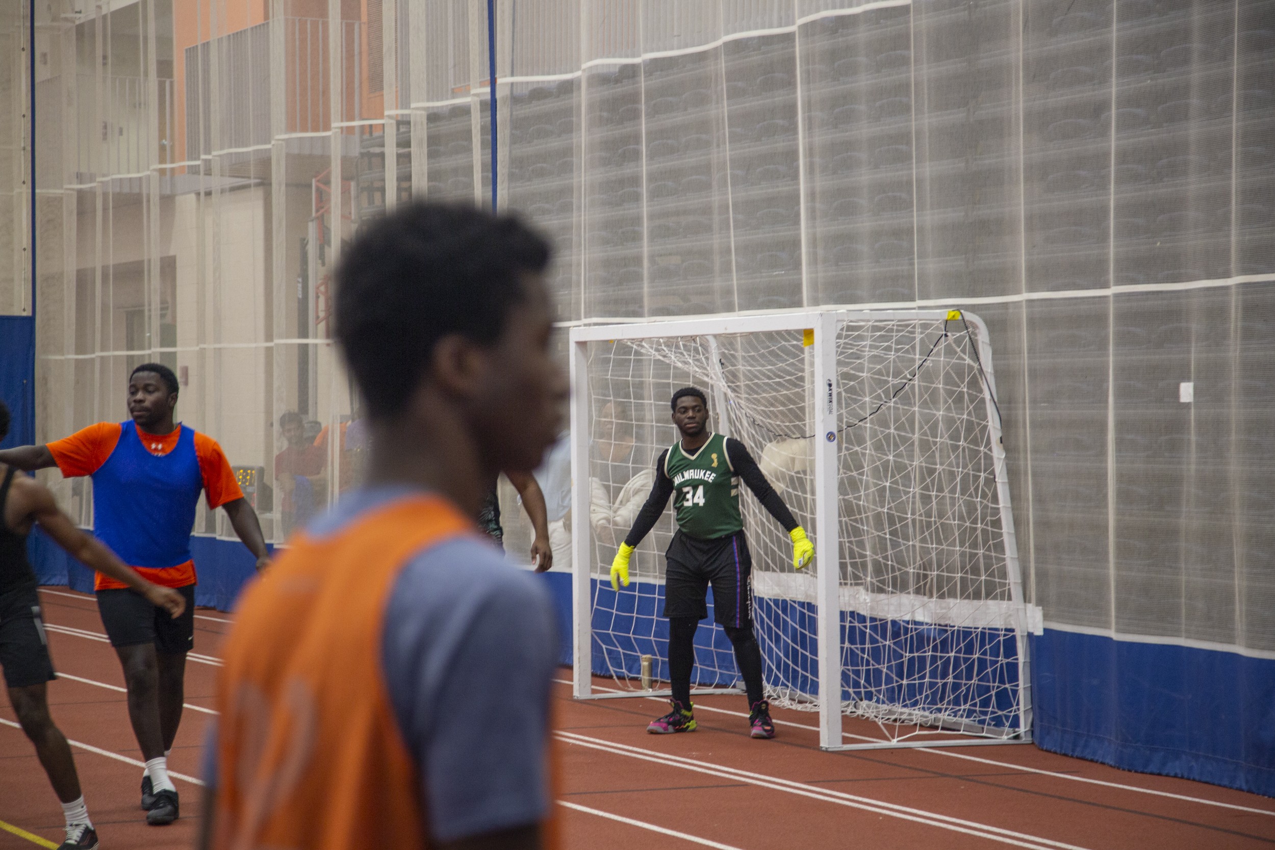 A group of students playing indoor soccer