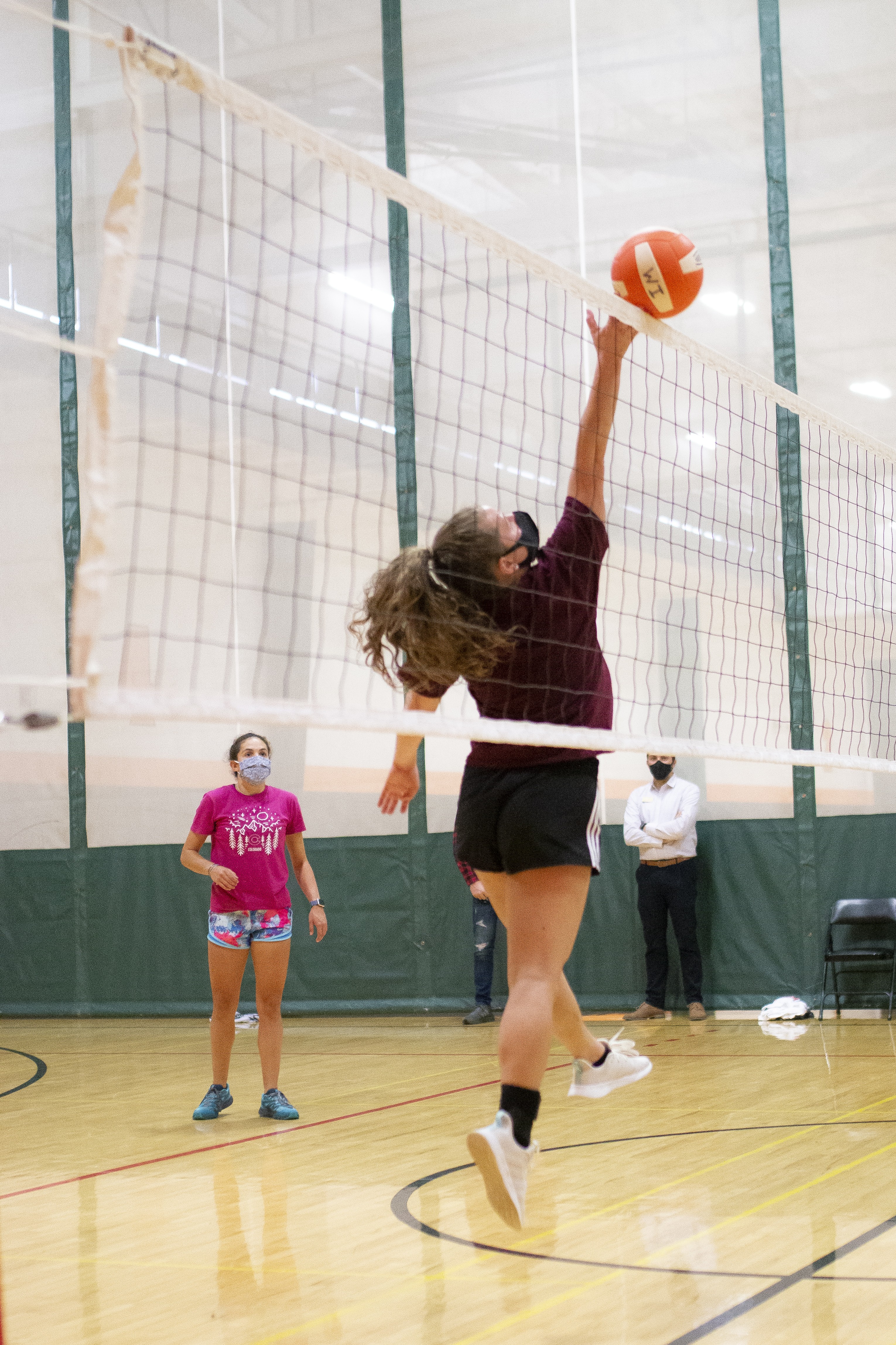 Students playing volleyball in indoor gym