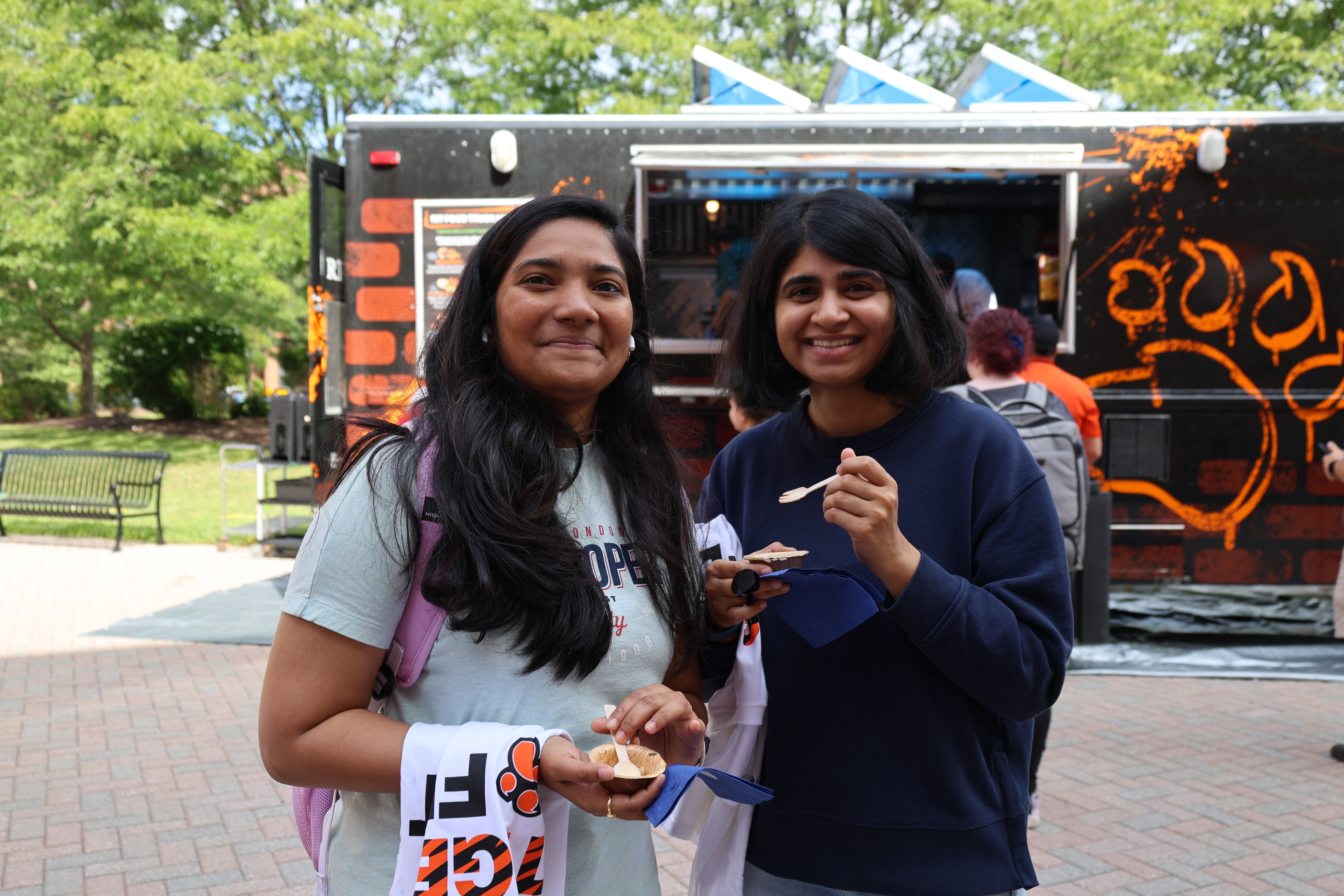 Two students in front of the RIT Food Truck outside the SAU at the Dining TigerFest event