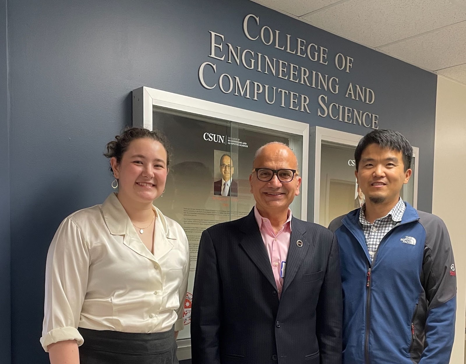 Margaret Grey poses with faculty at CSUN in front of a sign that reads College of Engineering and Computer Science