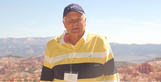 Bob Witmeyer BS ’71, MS ’76 standing outdoors with mountains as the backdrop