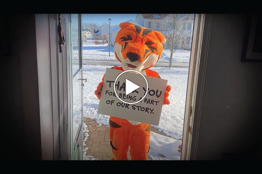 Ritchie outside of a doorway with a Thank You sign for our RIT donors.