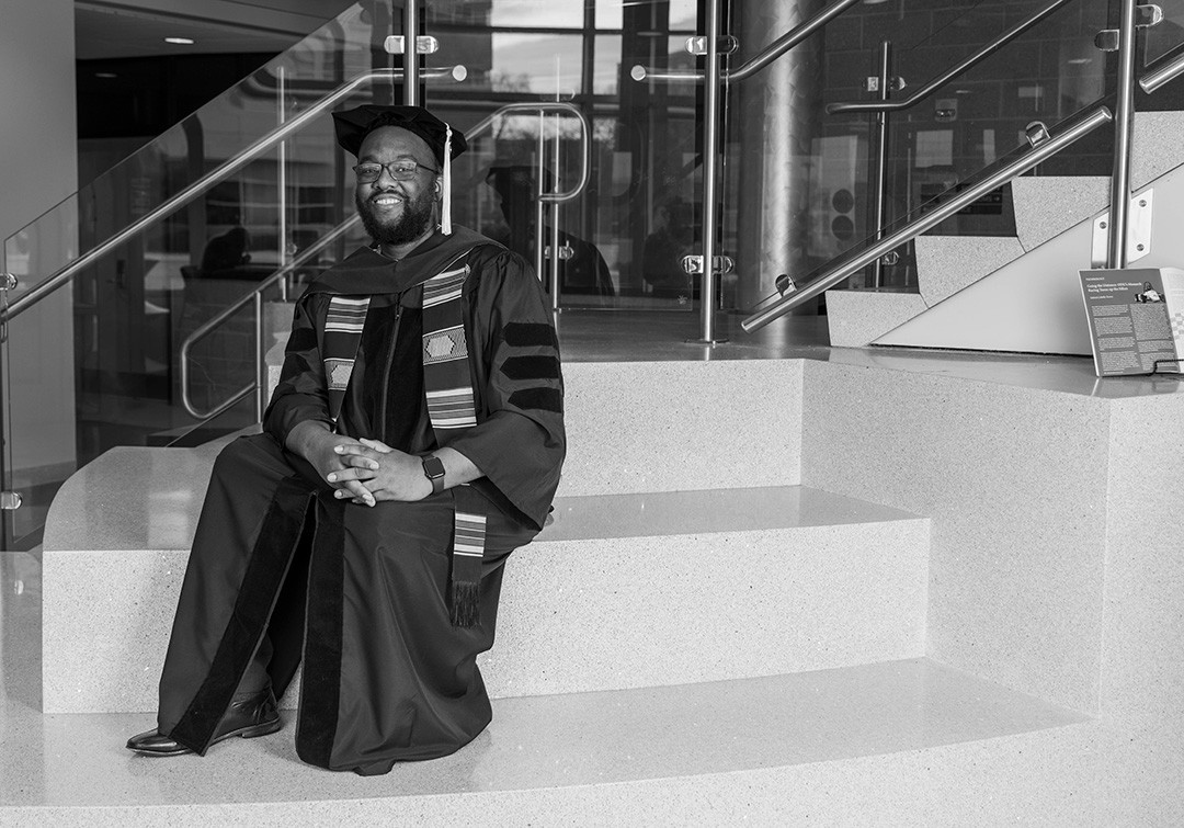 Student wearing his Ph.D. cap and gown.