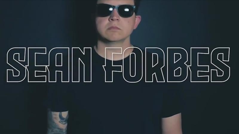 Man in black shirt and black sunglasses on black background