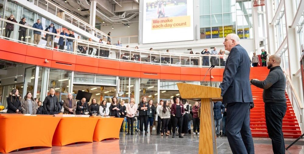 President Munson speaking to an audience inside of The SHED.