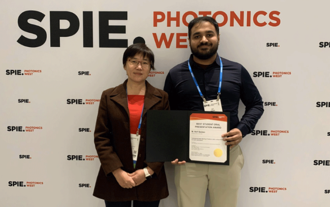 Muhammed Akif Qadeer, right, poses for a picture with Associate Professor Jie Qiao after winning an award for his research presentation at the 2026 SPIE Photonics West conference.
