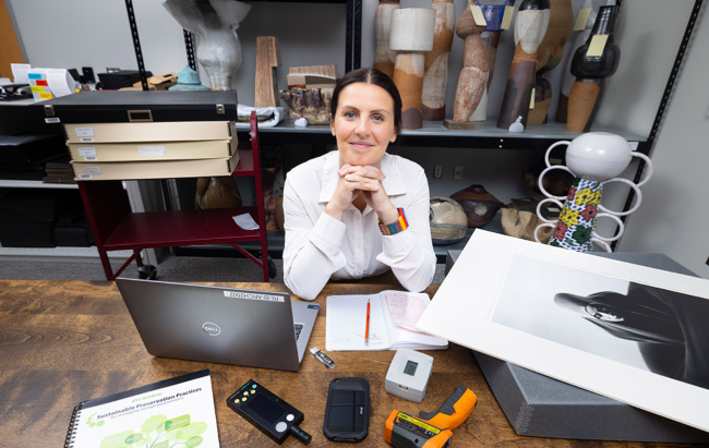 RIT preservation specialist working at a desk.