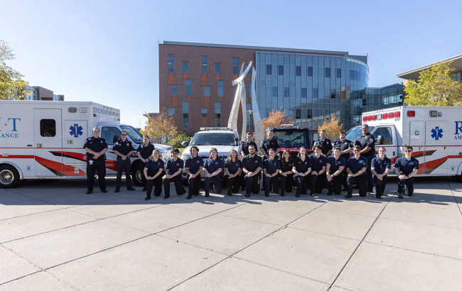 RIT Ambulance team poses with two ambulances.