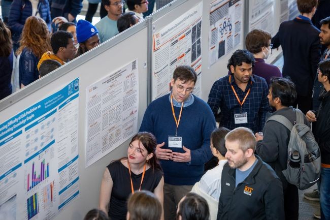 RIT graduate student Sidney Grabosky, center, talks about how people might use smartwatches in the future at the RIT Graduate Showcase, April 9.
