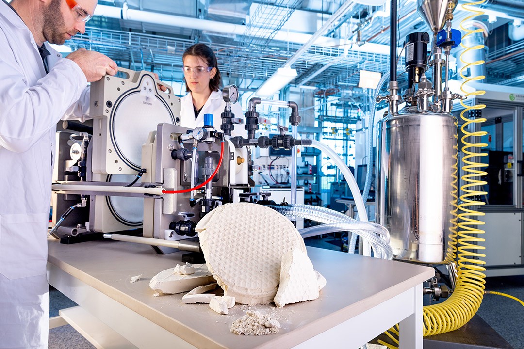 Researchers operating machinery in a high-tech laboratory.