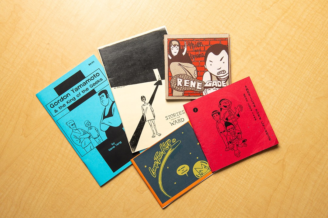 Published comics displayed on a table.