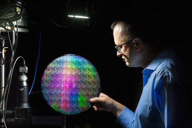 Professor Stefan Preble holds a quantum photonic wafer, which was first developed on RIT’s campus and is a key technological advancement in quantum photonic research.