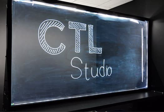 image of a lightboard set against a dark studio background with the words CTL Studio written on the glass