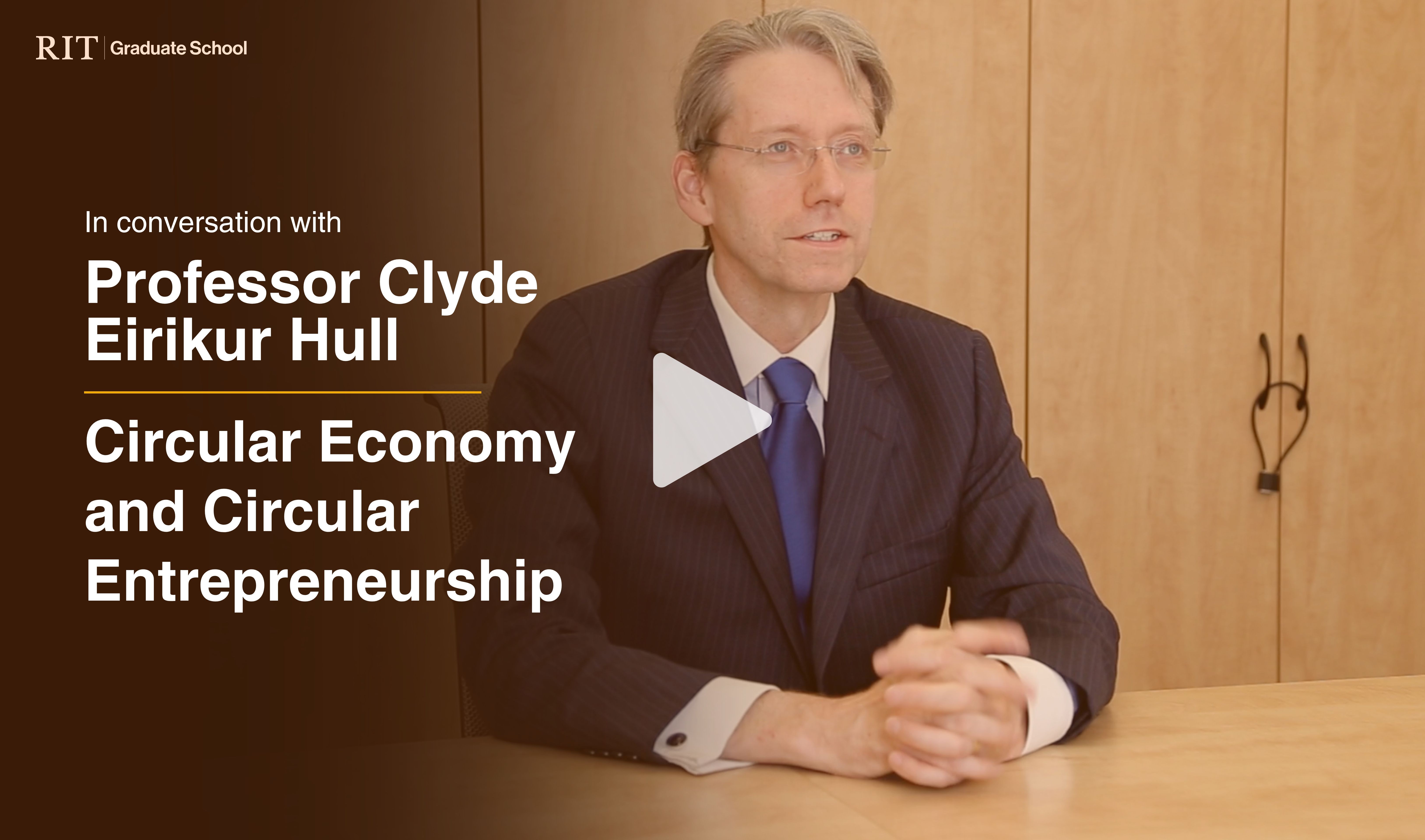 Professor Clyde sitting in front a shelf
