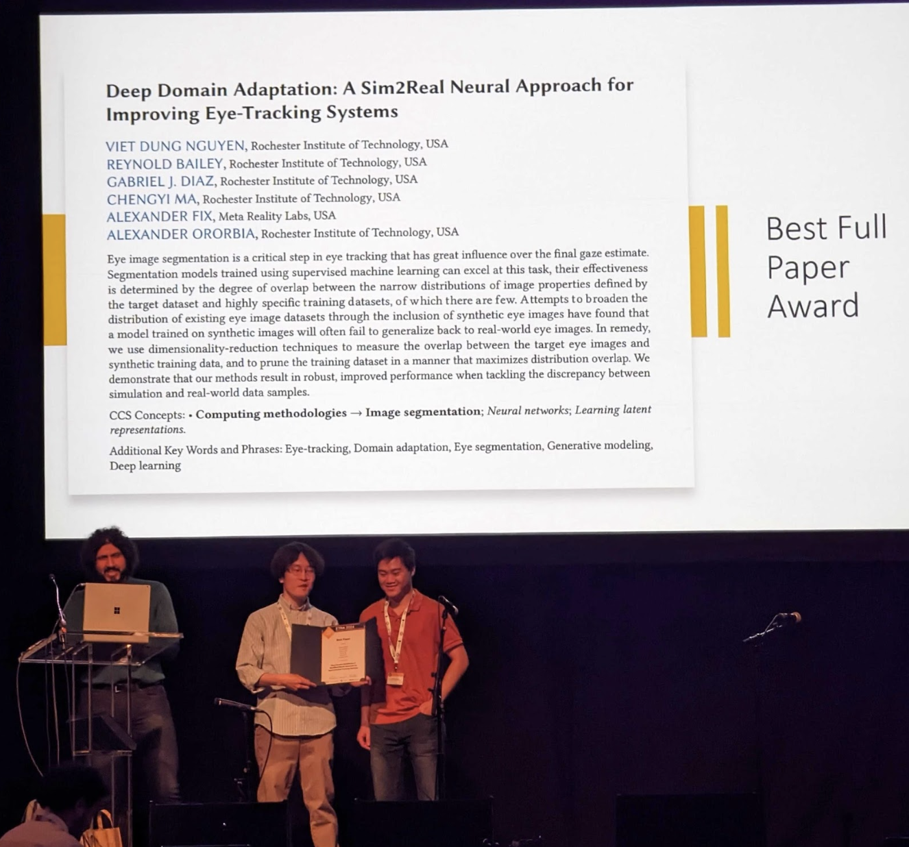 Viet Nguyen holding his award