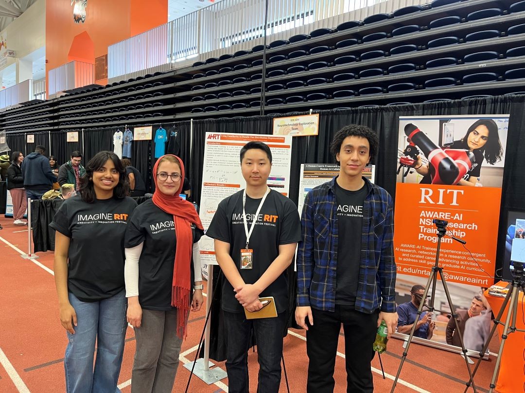 Liya Thomas, Marzieh Amiri Shahbazi, Gabriel Park, and Cedric Bone at the AWARE-AI exhibit at Imagine RIT in April 2024