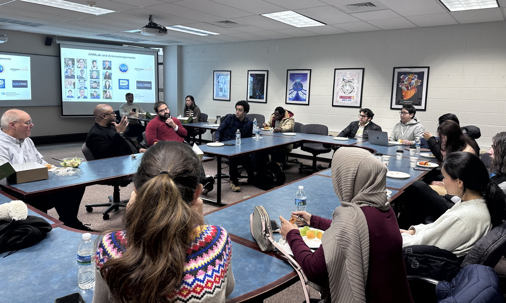 Dr. Monroe Kennedy III sitting and talking with students.
