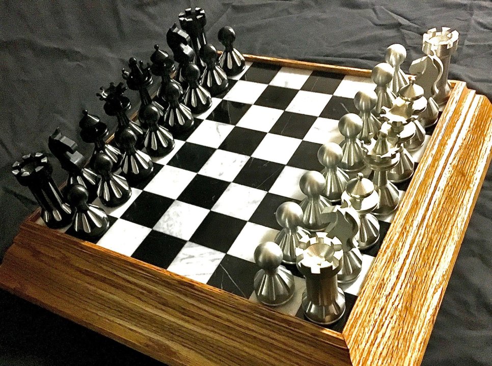 Description- Chess Set sitting on tiles and outside is a wood board. Two different colors for set