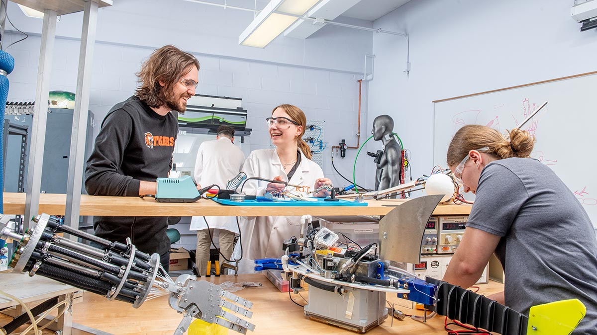 Students work together on a robotics project in a lab.