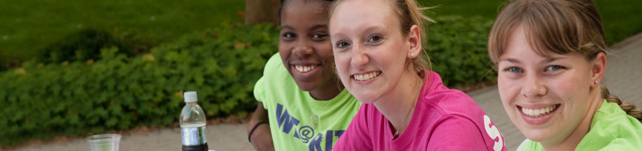 3 female students outside and smiling