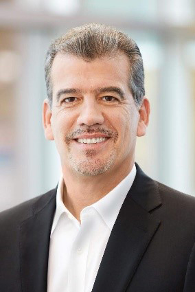 Headshot of Fernando Silva wearing a white collared shirt and a black blazer.