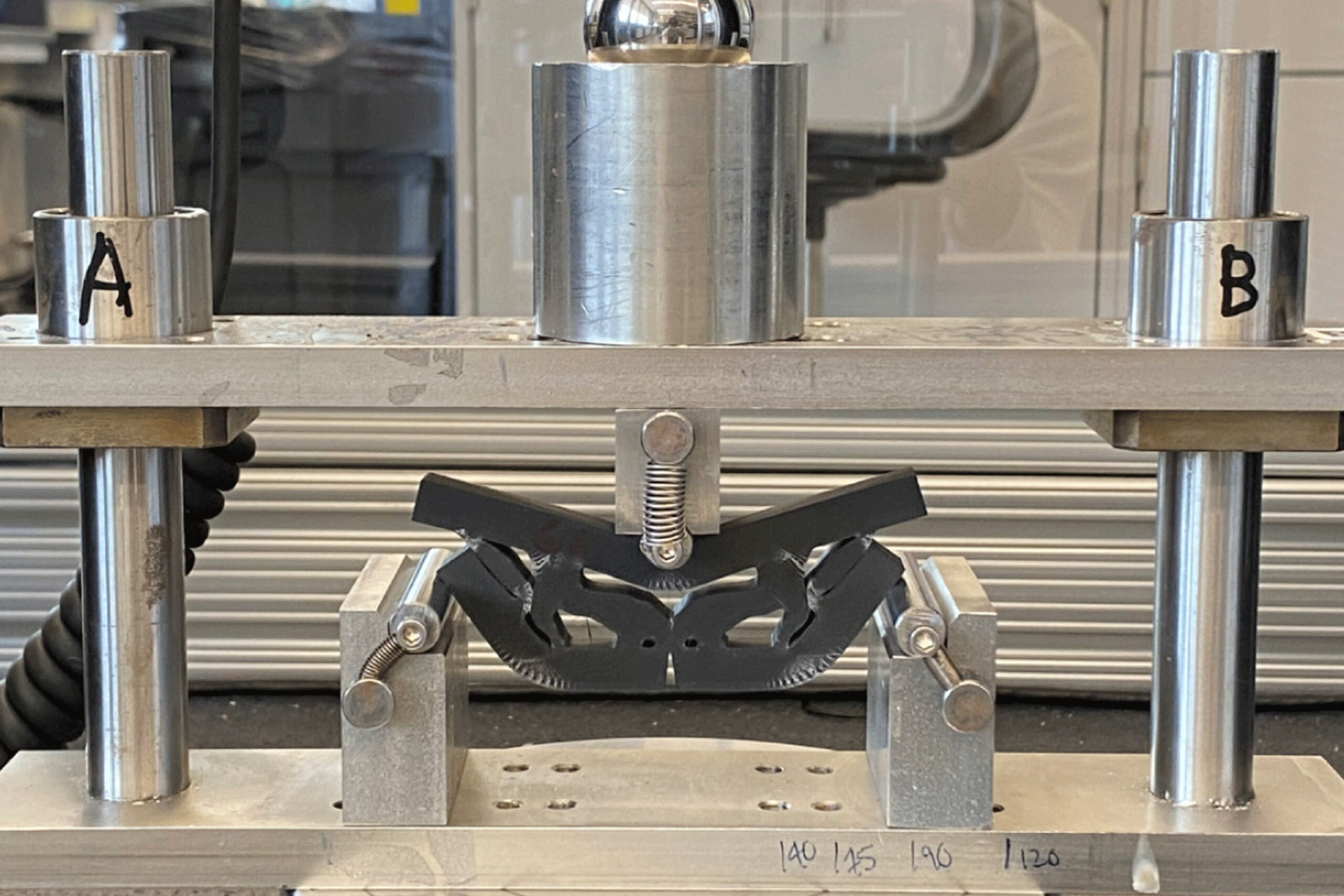 A silver machine in the Structural Integrity and Functionality Lab at RIT.