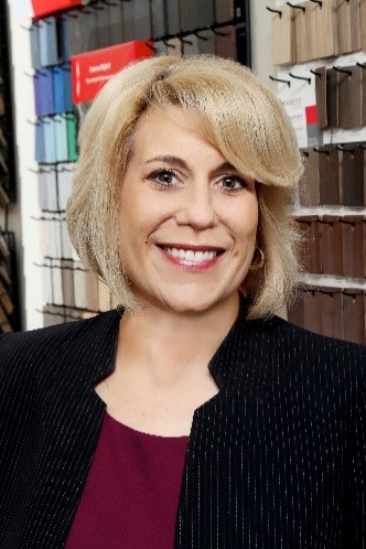A headshot of Christine Vargas wearing a black suit.