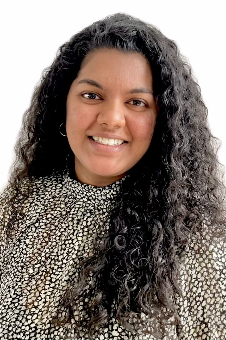 A headshot of Dimple Joseph wearing a black and white patterned blouse.
