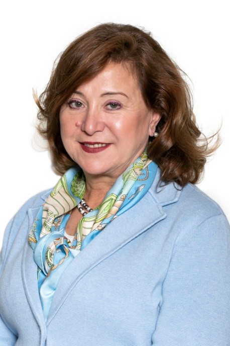 A headshot of Rose Carmichael wearing a blue suit jacket and a scarf.
