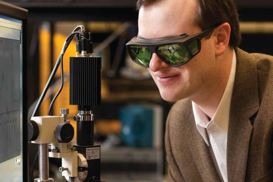 Man looking at instrument wearing special glasses.