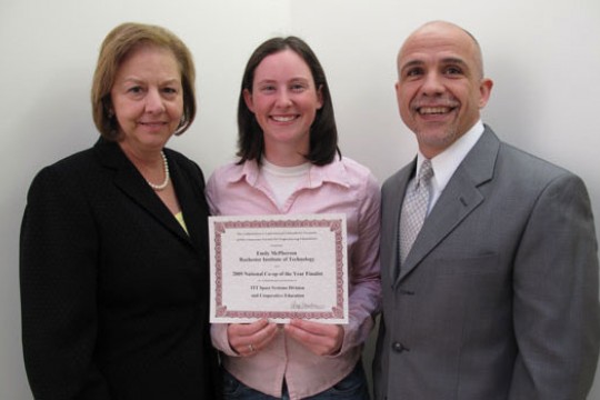 Student standing with award