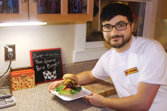 Person posing with burger