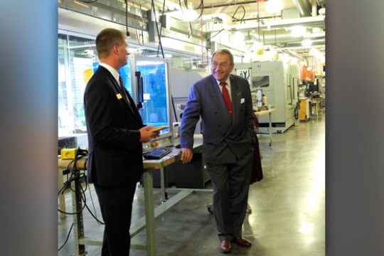 Two people talking in machine lab